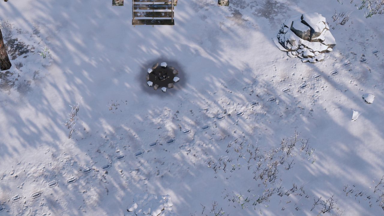A line of boot prints in sunlit snow, crossing past the cold campfire ring below the cabin.