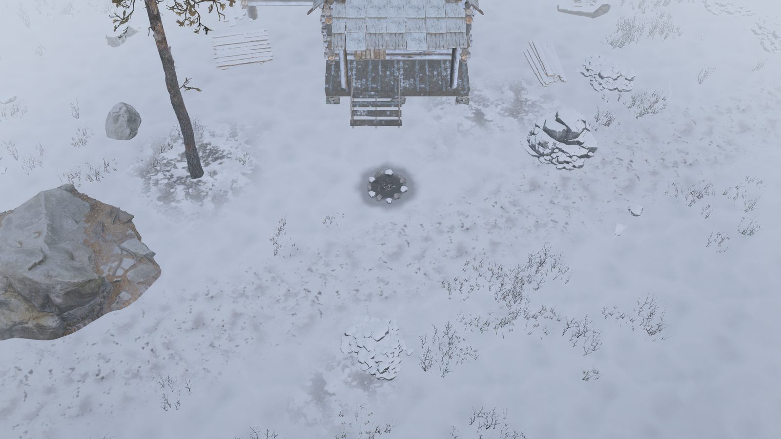 The same spot in fog, the cabin and trees fading to grey.