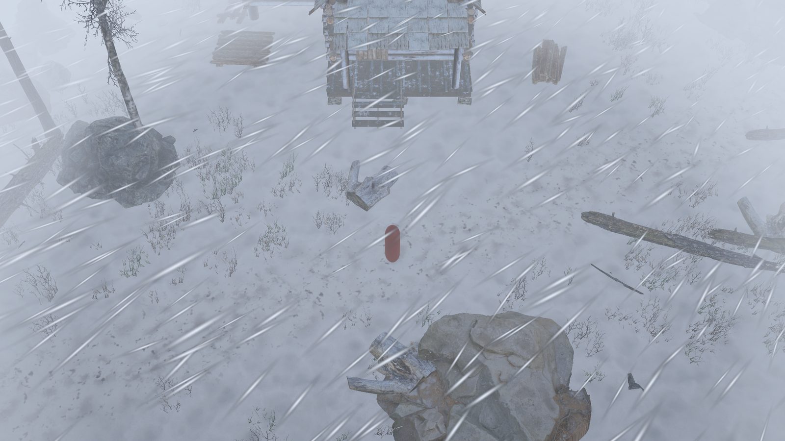The same place in a whiteout, with snow streaking sideways across the frame and the cabin and boulders fading into grey.